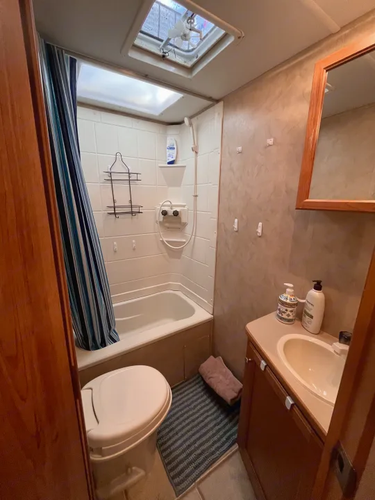 RV rental's compact bathroom features a tub, toilet, and sink vanity.. R-Vision Trail Sport 2014