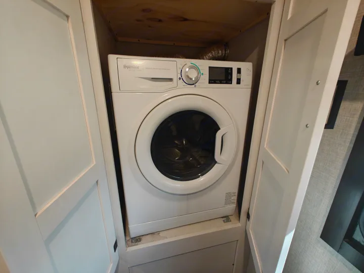 This RV rental features a compact Splendide automatic washer and vented dryer combo unit, ideal for laundry on the go.. Highland Ridge Open Range Light 2024