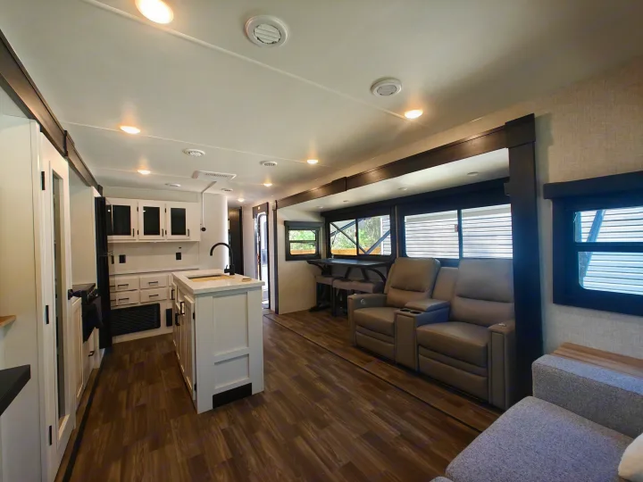 Spacious RV rental interior with a modern kitchen, living area featuring recliners, and a dining nook.. Highland Ridge Open Range Light 2024