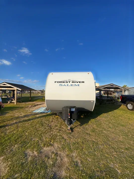 This Forest River Salem travel trailer is ready for your next rv rental adventure at a sunny campsite.. Forest River Salem 31kqbts 2025