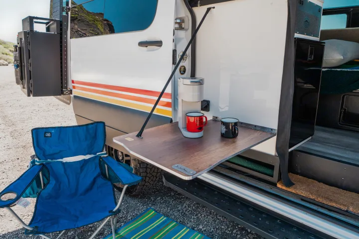 RV rental's convenient outdoor kitchen with Keurig coffee maker & mugs, plus a blue camping chair. Perfect for camp life!. Storyteller Overland Storyteller Overland Class B 2022