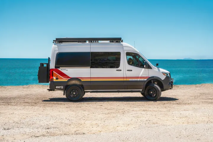 White Storyteller Overland camper van by the ocean, ideal for an RV rental or overland adventure.. Storyteller Overland Storyteller Overland Class B 2022