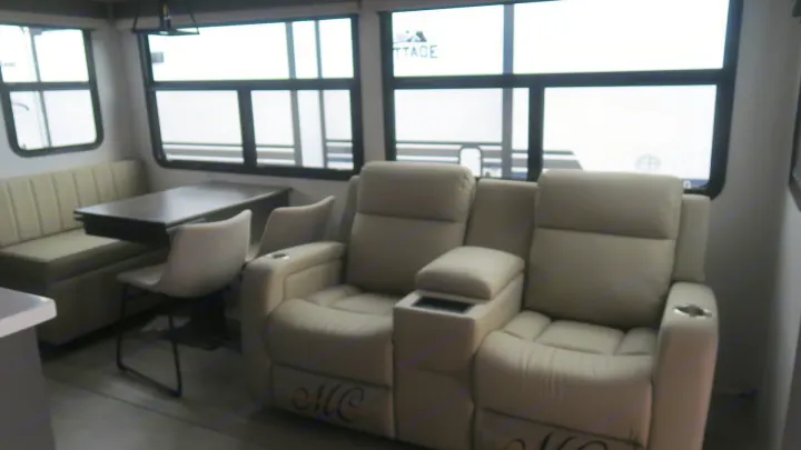 Cozy RV rental interior with comfortable recliners and a dinette. Perfect for your next road trip adventure.. Forest River Rockwood 2025