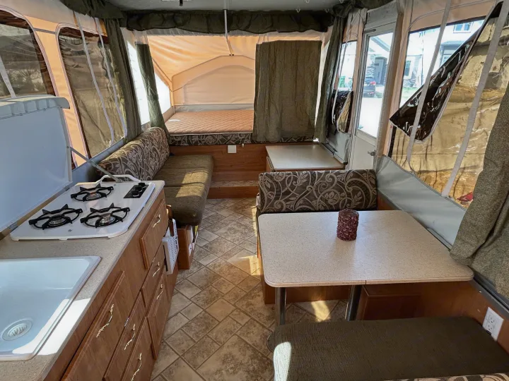Experience comfortable travel in this pop-up camper RV rental, featuring a kitchenette, dinette, and cozy sleeping area.. Forest River Flagstaff 2008