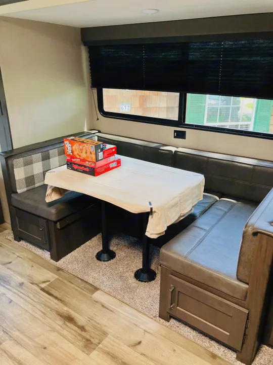 RV rental: Dinette with table, upholstered benches, and board games, perfect for cozy meals and entertainment.. Grand Design 265BH 2023