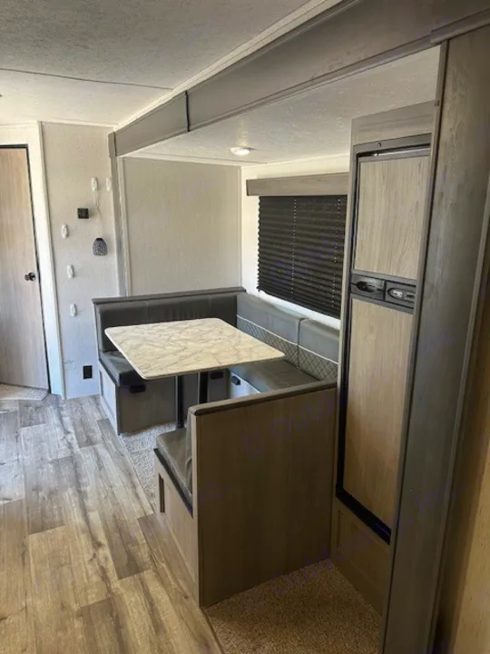 RV rental: Modern, bright interior featuring a comfy dinette with marble-look table & compact fridge.. Dutchmen Coleman Lantern 2022