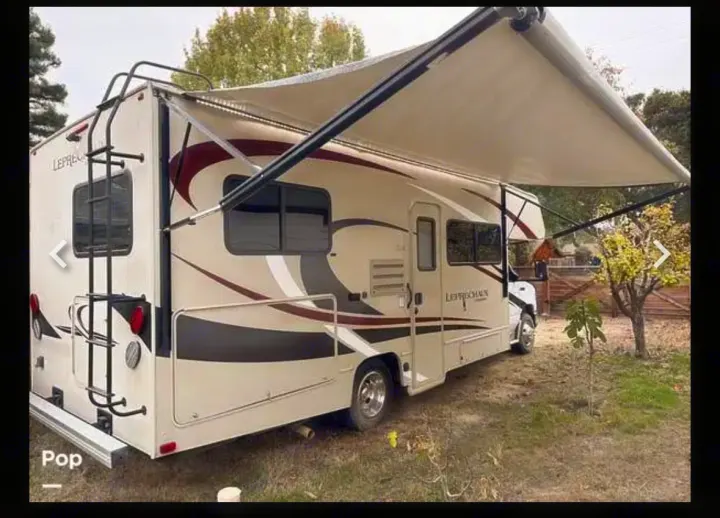 Leprechaun Class C RV rental featuring an extended awning and rear ladder for your travels.. Coachman Leprechaun 2020