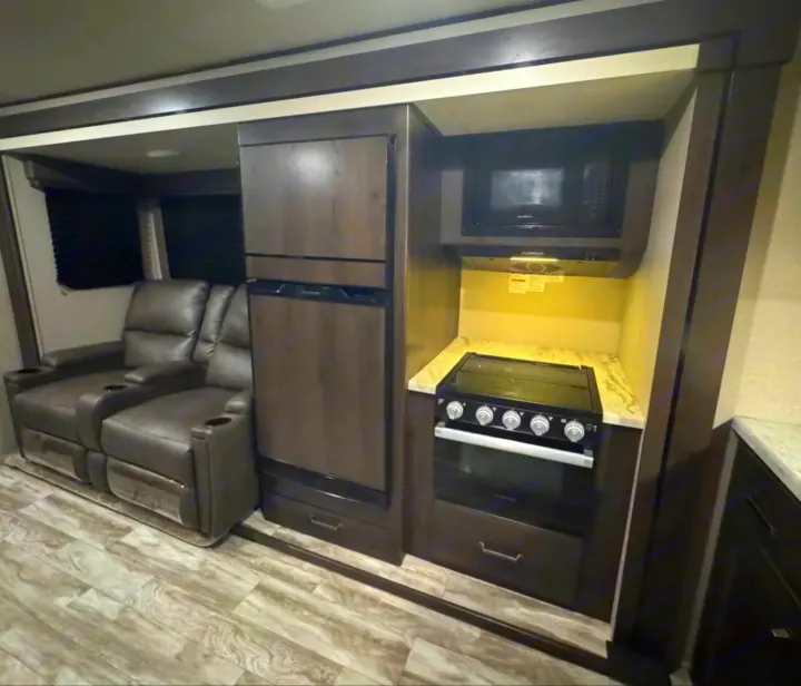 RV rental: Spacious interior with recliners, full kitchen (fridge, microwave, stove/oven), and slide-out for comfort.. Grand Design Transcend Xplor 2022
