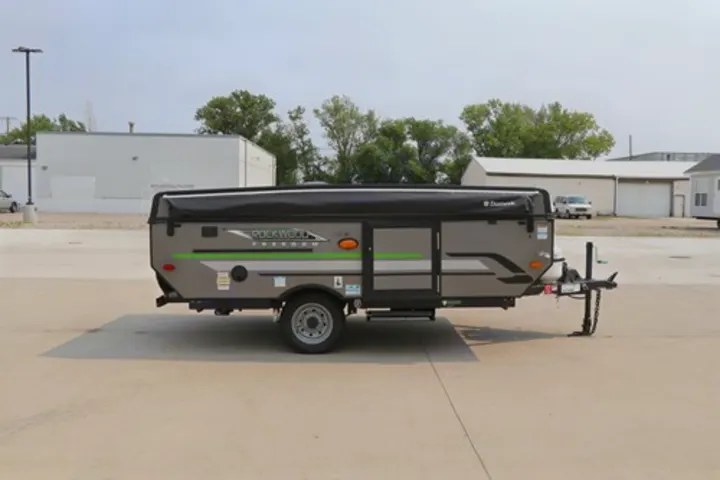 Gray Rockwood Freedom pop-up camper, an ideal RV rental option, parked on a paved lot for your next adventure.. Rockwood Freedom Series 2021