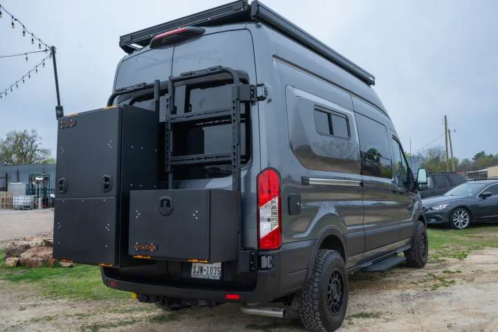 Grey custom camper van, ideal for rv rental, features unique rear storage boxes & an adventure-ready build.. Ford Transit Custom 2022