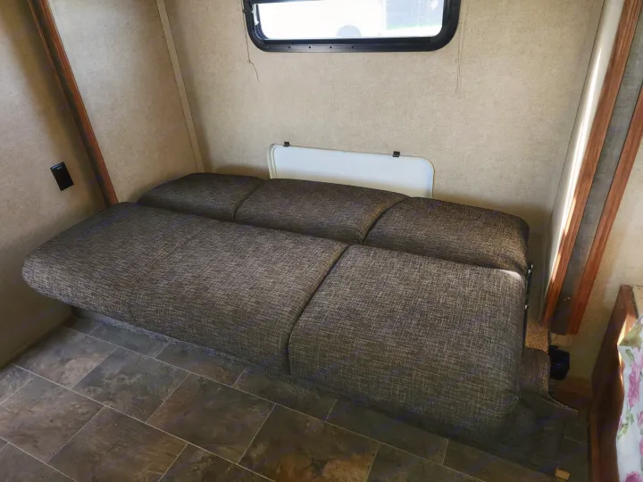 RV rental: Cozy interior featuring a convertible sofa bed, a window for natural light, and durable tiled flooring.. Forest River Rockwood Mini Lite 2014