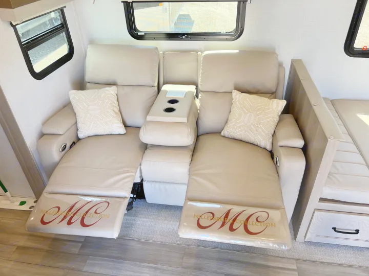 Comfortable RV rental interior featuring dual recliners with a center console, perfect for relaxing after a journey.. Forest River Rockwood Ultra Lite 2024