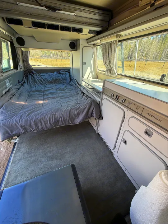 Westfalia RV rental interior: a comfy bed, integrated kitchen, and pop-top roof.. Volkswagen T3 1991