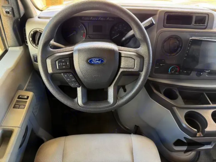 Ford RV rental interior: Driver's cockpit view with steering wheel, dashboard, touchscreen display, and console controls.. Coachmen RV Freelander 26DS 2023
