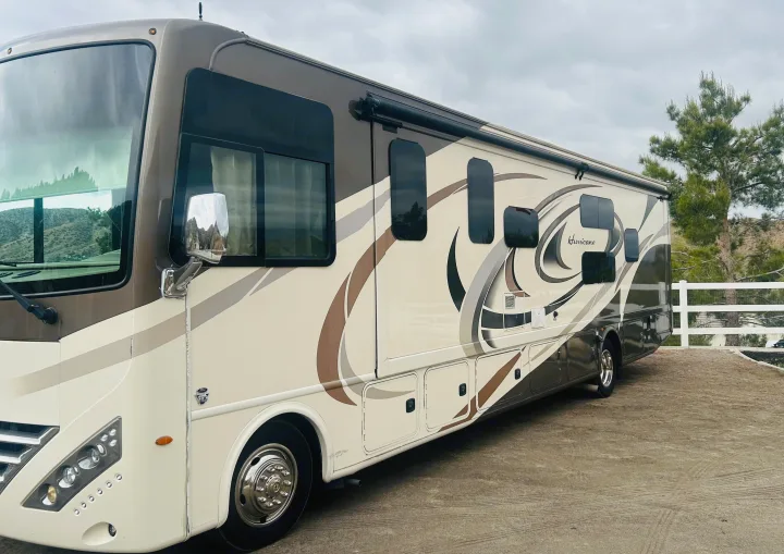 A stylish Thor Hurricane RV rental, a motorhome, parked outdoors, ready for your next adventure.. Thor Hurricane 2018