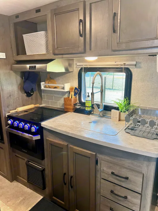 Stylish and fully equipped rv rental kitchen, featuring modern appliances & ample storage for comfortable travels.. Coachmen 226 BH 2019