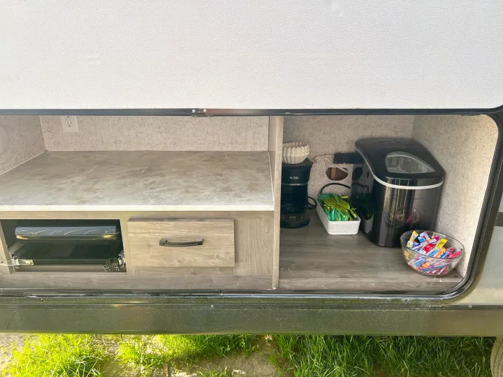 Discover the convenience of this RV rental's outdoor kitchen, featuring a coffee maker, ice machine, and pull-out grill.. Coachmen 226 BH 2019