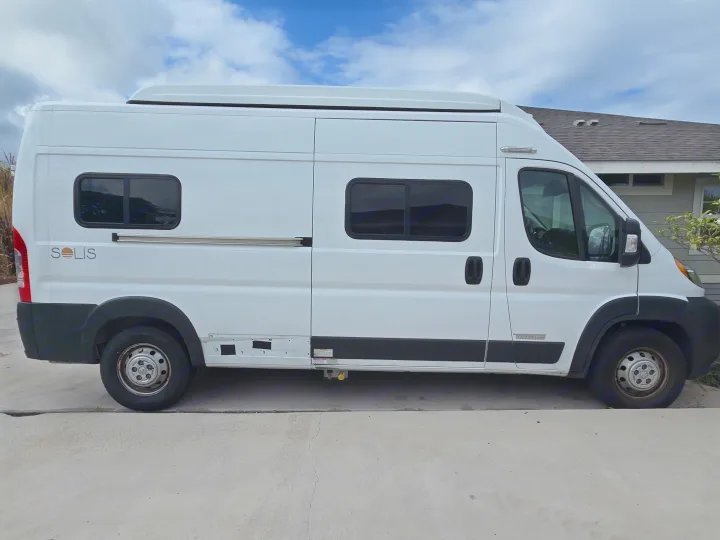 A white Winnebago Solis camper van, perfect for RV rental, parked on concrete outdoors under a blue sky.. Winnebago Solis 2023