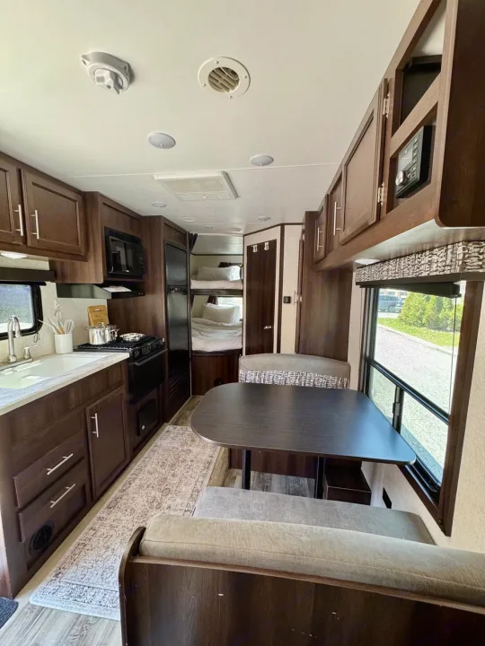 RV rental interior: full kitchen, dinette, and bunk beds in a modern travel trailer. Perfect for family adventures.. Jayco Jay Flight SLX 2019
