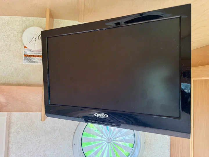 This RV rental features a mounted Jensen TV and a smoke detector, essential for safety and entertainment on the go.. Pleasant Valley/NuCamp T@B 2016