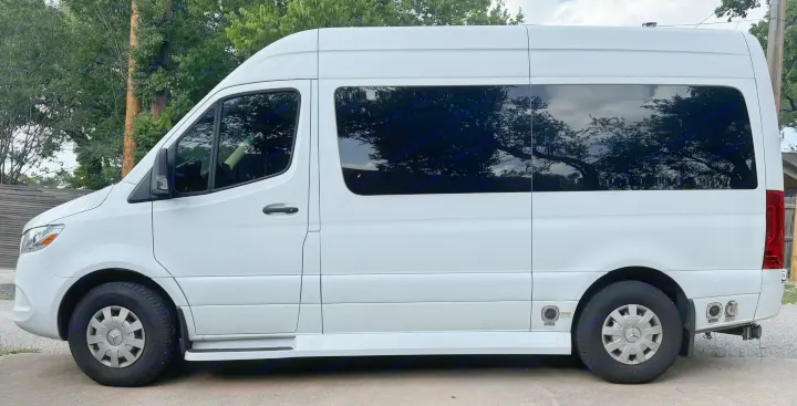 Side view of a white Mercedes-Benz Sprinter camper van, a popular choice for RV rental, parked on concrete.. Ultimate Toys Ultimate Commuter 144 2022