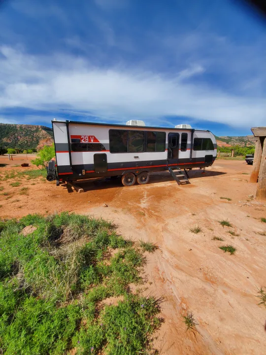 Experience outdoor adventure with this Forest River 29V rv rental parked in a picturesque desert landscape.. Forest River Salem Platinum 2024