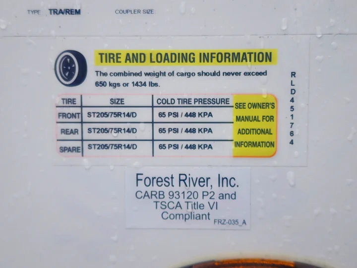 Important RV rental info: tire sizes, cold pressure (65 PSI), & 650 kgs cargo limit on this vehicle label.. Forest River Rockwood Mini Lite 2023