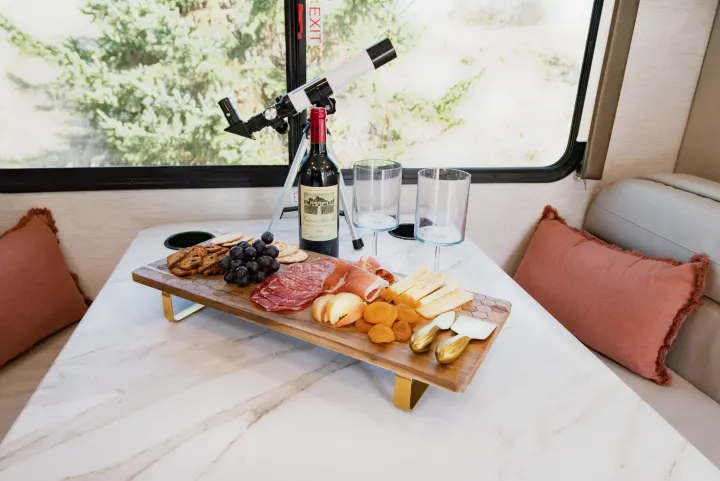 Relax in your RV rental with a delicious charcuterie spread, wine, and a telescope to enjoy the views.. Thor Motor Coach Eddie Bauer 21EBF 2025