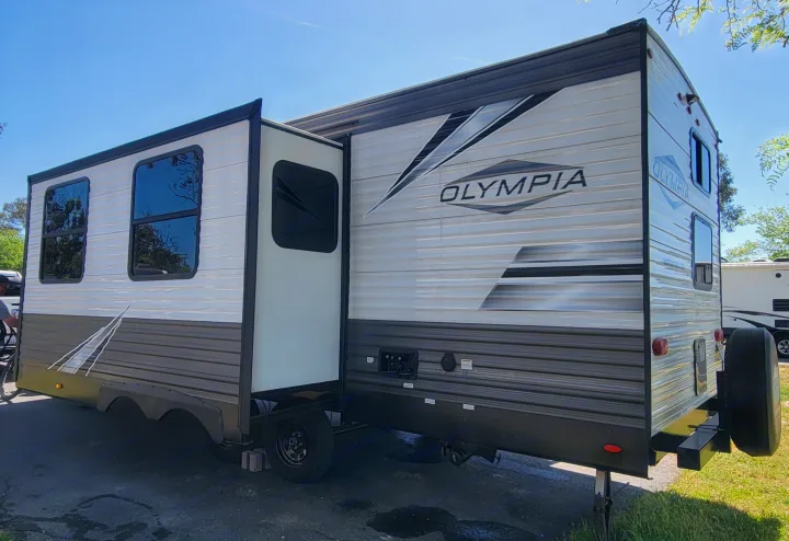 Spacious Olympia travel trailer, perfect for your next RV rental adventure. Parked with slide-out extended.. Highland Ridge RV Olympia 2022