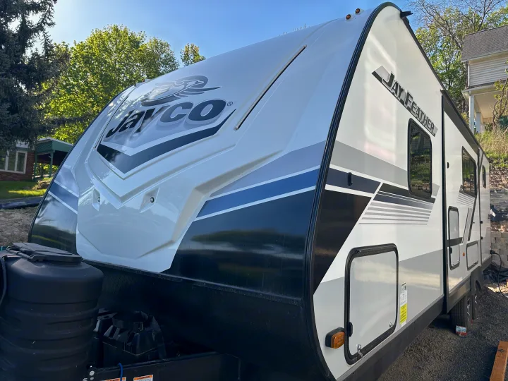 Jayco Jay Feather travel trailer, white and black, perfect for an RV rental. Ready for camping adventures.. Jayco Jay Feather 2024