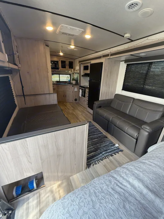 Spacious RV rental interior with a cozy living area, full kitchen, and bedroom, ideal for travel adventures.. Forest River Coachmen Northern Spirit Ultra Lite 2023