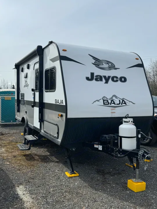 White and gray Jayco Baja travel trailer, equipped for an RV rental outdoor adventure.. Jayco Jay Flight SLX Baja Edition 2022