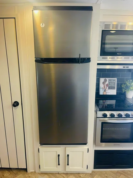 This RV rental features a compact kitchen with a stainless steel refrigerator, microwave, and oven.. Forest River Palomino Puma 2022