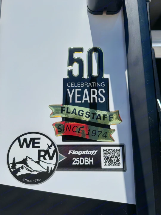 This Flagstaff 25DBH RV proudly displays 50th-anniversary 'Since 1974' and 'WE RV' emblems. Perfect for your RV rental.. Flagstaff Micro Lite 25DBH 2025