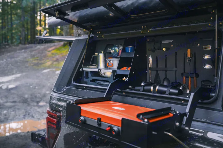 RV rental overland kitchen: pull-out stove, kettle, cups & organized cooking gear in a truck bed for trailside meals.. Ford Ford F150 2024