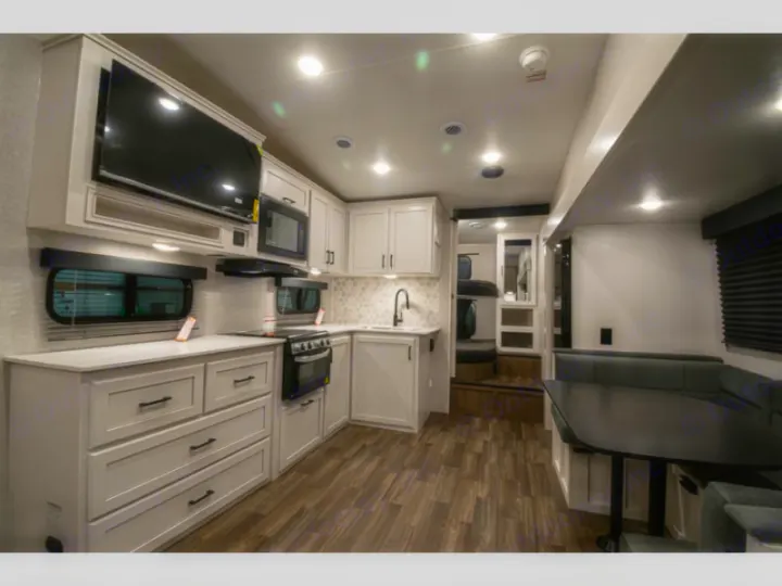 Spacious RV rental interior with modern kitchen, dinette, and bunk area for comfortable travel.. Jayco Eagle Super Lite 2025