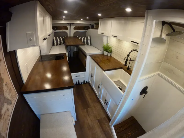 Explore this clean, modern RV rental. It features a full kitchen, convertible dining/sleep area, and a functional shower.. Dodge Ram 1500 2019