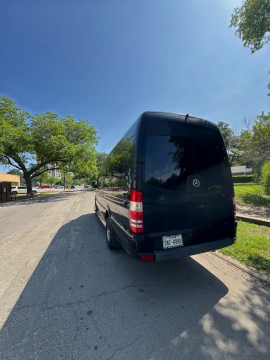 Black Mercedes Sprinter van, possibly an RV rental, parked on a sunny street with trees. TX plate SMZ-0880.. Mercedes-Benz Sprinter 2015