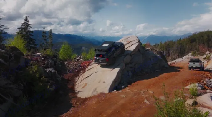 Experience off-roading! A dark SUV on a rock and a pickup navigate rugged mountain trails, ideal for an RV rental adventure.. Toyota 4Runner 2025