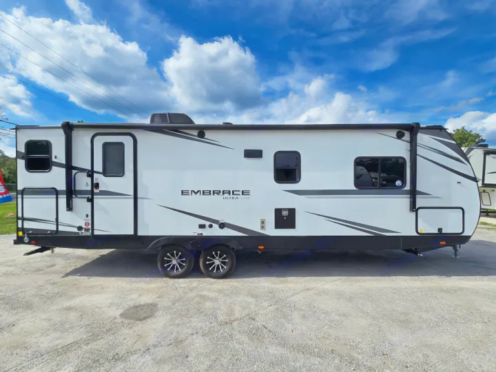 This modern white Embrace Ultra-Lite travel trailer is ideal for an RV rental adventure.. Cruiser Embrace EL26RB 2024
