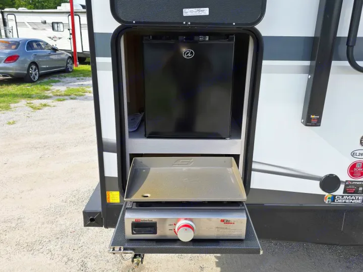 This RV rental boasts an outdoor kitchen with a compact fridge and a pull-out Suburban griddle, perfect for convenient camping.. Cruiser Embrace EL26RB 2024