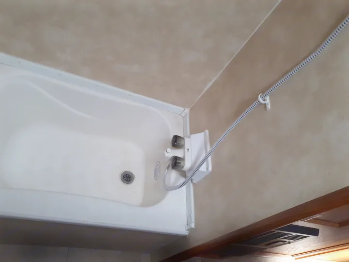Compact RV rental shower-tub combo with wall-mounted fixtures. Essential for life on the road!. Coachmen Clipper 2013