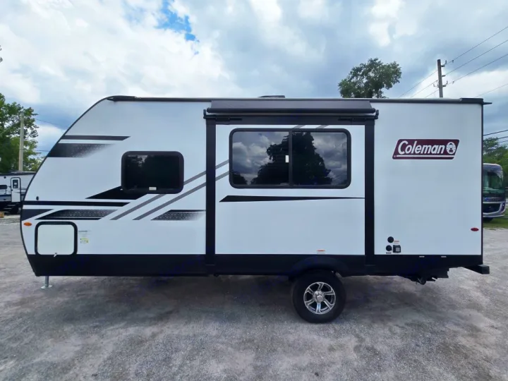 Side view of a white Coleman travel trailer with black and gray graphic details, perfect for RV rental.. Coleman 1855RB 2022
