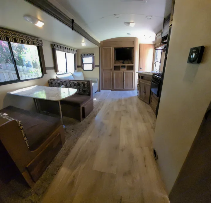 This RV rental offers a clean interior with a cozy dinette, modern kitchen, and entertainment unit for comfortable travels.. Cruiser RV Radiance 2015