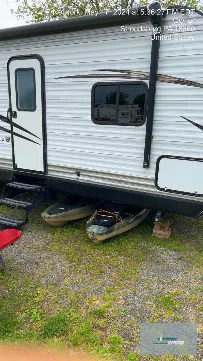 A cozy RV rental with two camouflage kayaks stored below, ready for your Stroudsburg outdoor adventures.. Jayco Jay Flight 2018