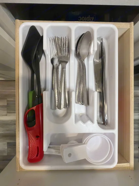RV rental kitchen drawer neatly organized with silverware, measuring cups, and cooking utensils.. Jayco Jay Flight SLX 170BHW 2025