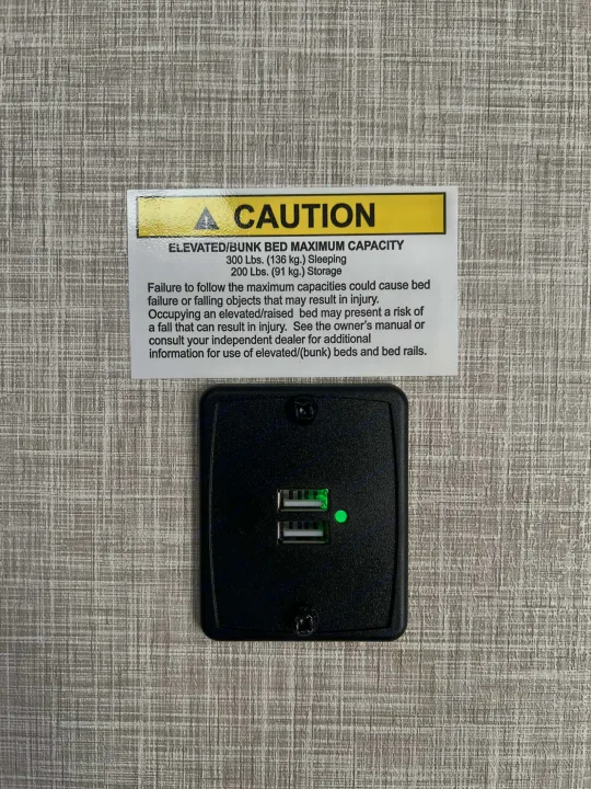 Important RV rental safety: elevated/bunk bed caution label with 300 lbs sleep & 200 lbs storage limits, plus USB ports.. Jayco Jay Flight SLX 170BHW 2025