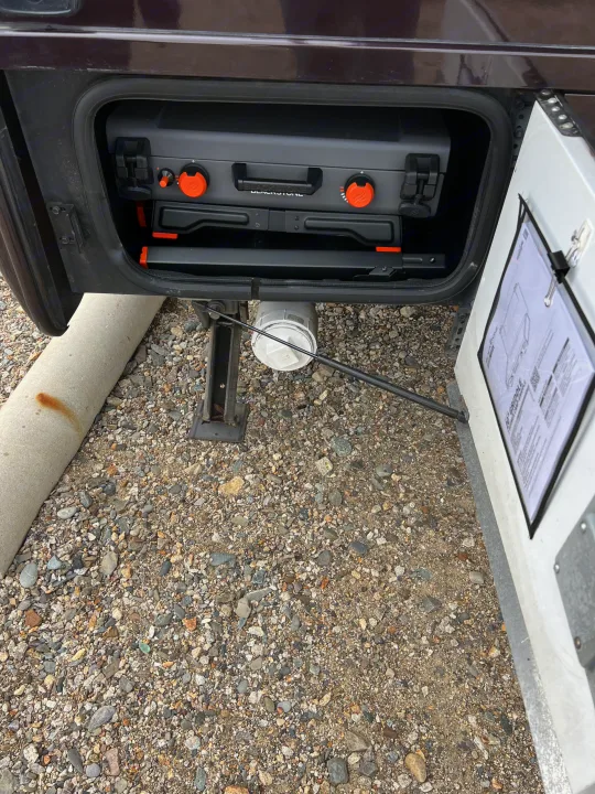 RV rental with a portable Blackstone griddle in its dedicated storage compartment, ready for outdoor cooking.. Thor Siesta 2017