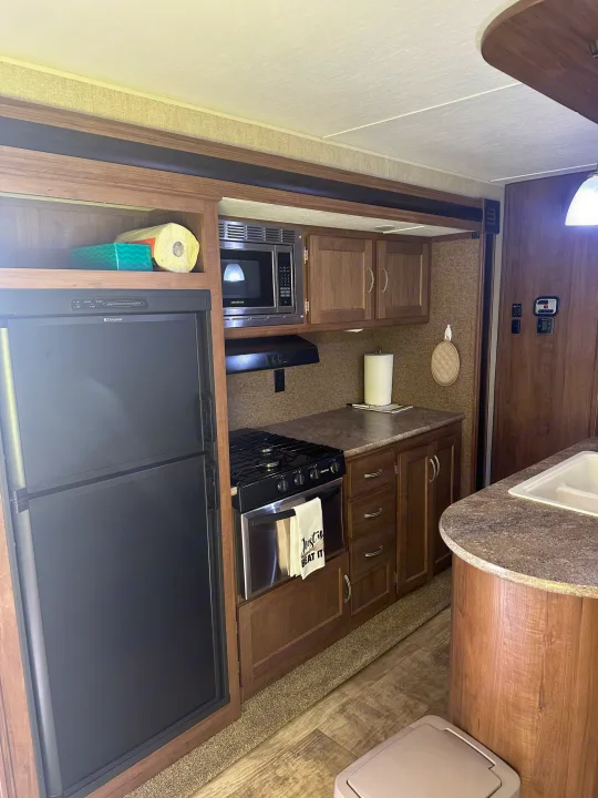 RV rental: Well-equipped kitchen interior with refrigerator, microwave, stove, and ample counter space for travel and camping.. Gulf Stream Conquest 2017