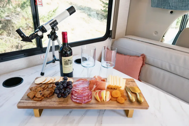 Enjoy a relaxing evening in your RV rental with a charcuterie board, wine, and a telescope for stargazing.. Thor Motor Coach Eddie Bauer 21EBF 2025